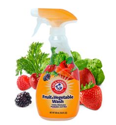 a bottle of fruit vegetable wash surrounded by fresh fruits and vegetables on a white background