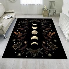 a living room area rug with three phases of the moon and stars on black background