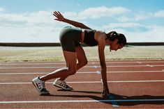 a woman stretching on a running track