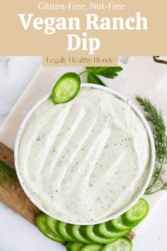 a bowl filled with ranch dip surrounded by cucumbers