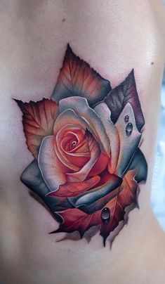 a woman's stomach with a rose and leaves tattoo on the side of her belly