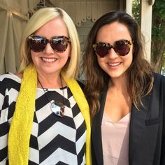 two women standing next to each other wearing sunglasses