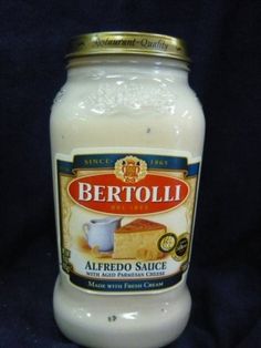 a jar of white sauce sitting on top of a blue cloth