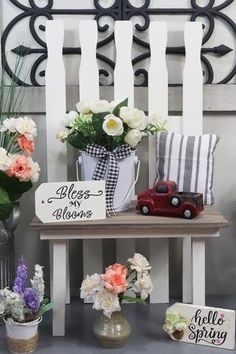 some flowers are sitting on a table with a sign that says roses blooming next to them