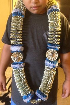 a young boy wearing a necklace made out of metal parts