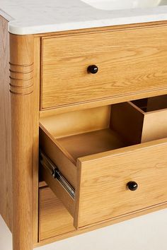 a wooden cabinet with two drawers and a sink