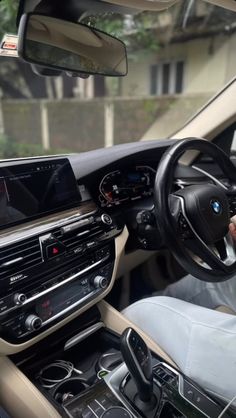 the interior of a car with dashboard, steering wheel and touchscreens on display