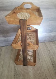 two wooden boxes with designs on them sitting on the floor