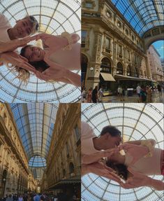 two people are posing for pictures in the middle of a shopping mall with glass ceiling