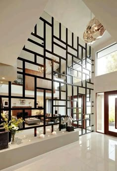 the interior of a modern house with white flooring and black lines on the wall