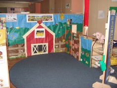 an indoor play area for children with toys on the floor and in front of it