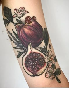 a close up of a person's arm with a tattoo on it and flowers