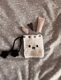 a crocheted bag with some items on it