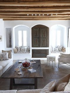 a living room filled with furniture and windows