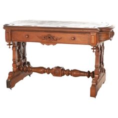 an old wooden table with marble top