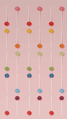 candy lollipops hanging on a pink background