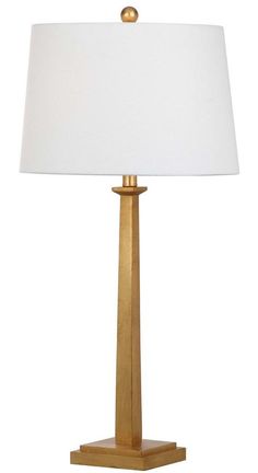 a gold lamp with a white shade on it