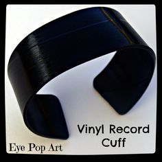 an eye pop art vinyl record cuff is shown on a white background with black text