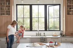 a woman and her daughter are in the kitchen