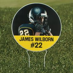 a football player holding a helmet on top of a field with the name james wilborn 22