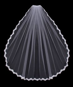 a veil with white lace on the top and bottom is shown against a black background