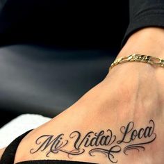 a woman's foot with the words mr and mrs lucas tattooed on her left side