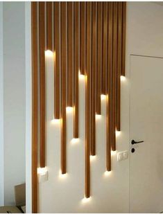 the lights are on in front of the door and behind it is a wooden slatted wall