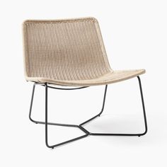 a chair that is made out of wicker and black metal legs, with a white background