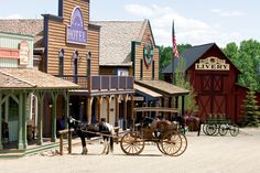 a horse drawn carriage parked in front of a building