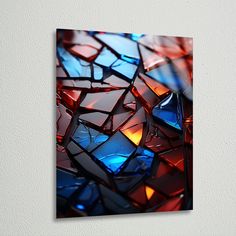 a close up of a colorful glass mosaic on a white wall with a black frame