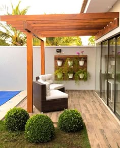 an outdoor living area with potted plants on the wall