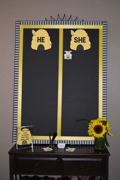 a black and white checkered table with a yellow sign on it that says he she