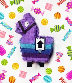 a purple horse made out of paper surrounded by colorful candies