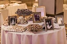 a table topped with pictures and desserts covered in frosting next to framed photos