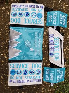 three blue and white banners laying on the ground