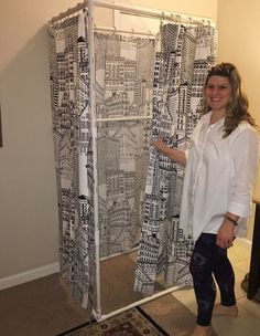 a woman standing in front of a shower curtain with black and white designs on it