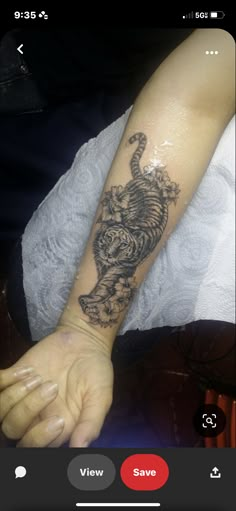 a person with a tiger tattoo on their arm