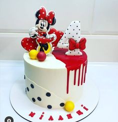 a mickey mouse cake with red and white decorations