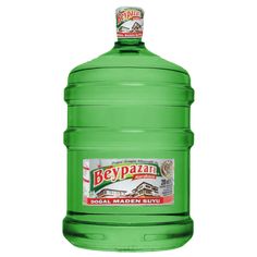 a large green bottle of beverage on a white background