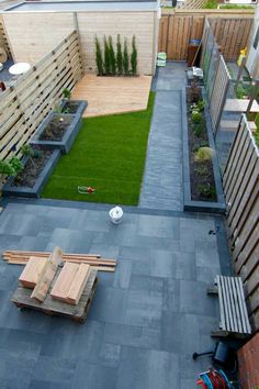 an aerial view of a small backyard with grass and wooden fenced in areas around it