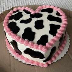 a heart shaped cake sitting on top of a cardboard box