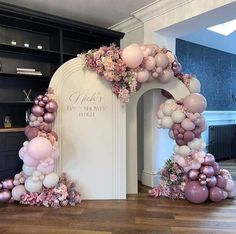 an arch made out of balloons and flowers