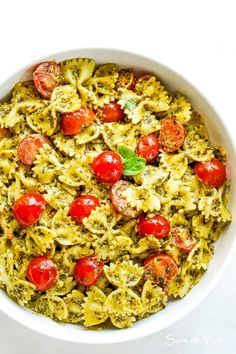 a white bowl filled with pasta and tomatoes