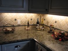 a kitchen counter with wine bottles on it