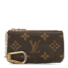 a brown louis vuitton wallet with gold hardware and keychain on the front