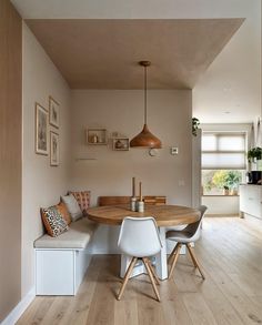 a dining room table with two chairs and a bench