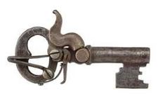 an old metal object with a cat on it's back and two keys attached to it