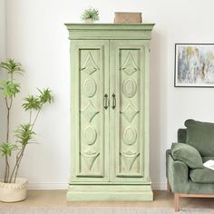 a green armoire sitting in the corner of a living room