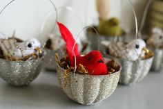 small tin cups with tiny birds in them