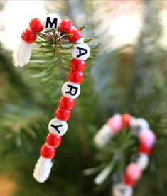 a christmas ornament hanging from a tree with the word merry written on it